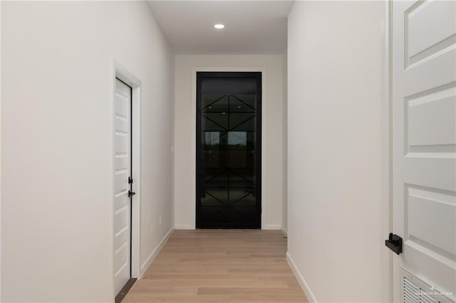 hall featuring baseboards, recessed lighting, visible vents, and light wood-type flooring