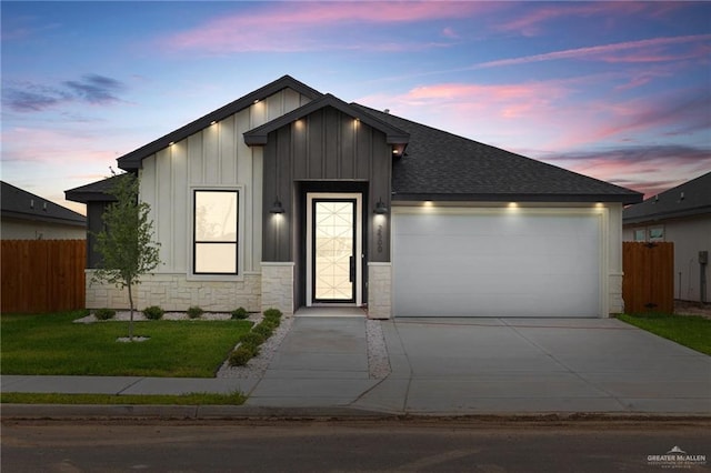 view of front of home with an attached garage, fence, concrete driveway, board and batten siding, and roof with shingles