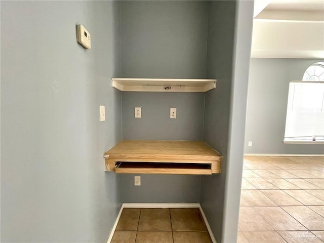 interior space featuring tile patterned flooring and baseboards