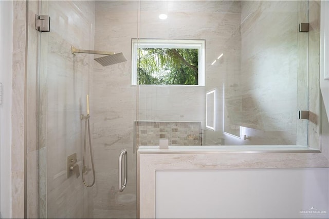 bathroom featuring a shower with door