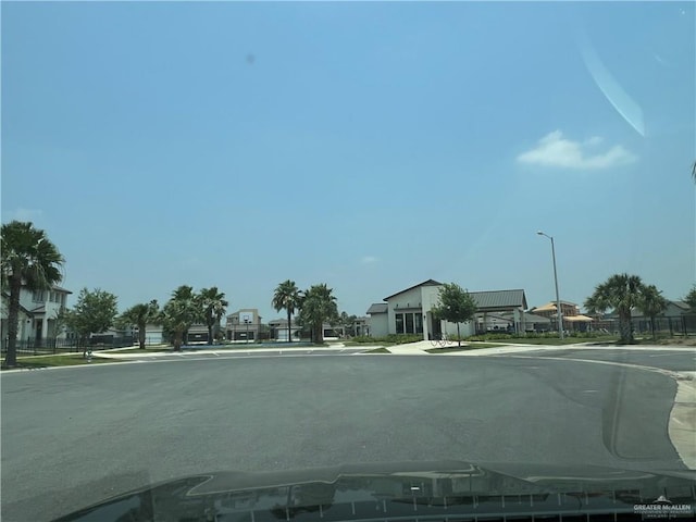10228 N 14th St, Mcallen, TX 78504 - view of asphalt street featuring street lighting, sidewalks, a residential view, and curbs