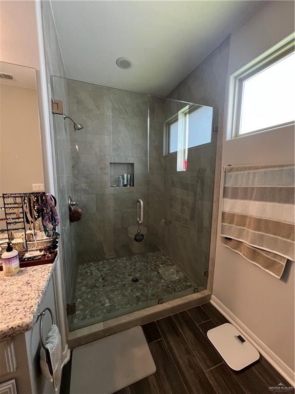 10228 N 14th St, Mcallen, TX 78504 - full bath with a stall shower, vanity, and wood finished floors
