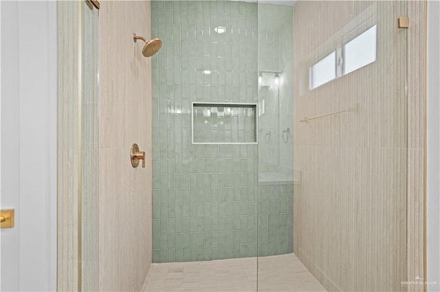 bathroom with a tile shower