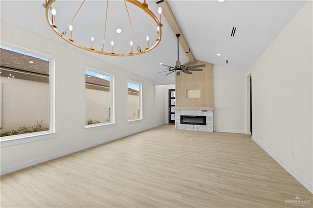 unfurnished living room with high vaulted ceiling, a high end fireplace, ceiling fan with notable chandelier, beam ceiling, and light hardwood / wood-style floors