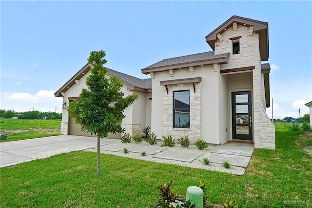 view of front of property featuring a front yard and a garage