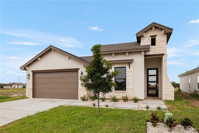 view of front of property with a front yard and a garage