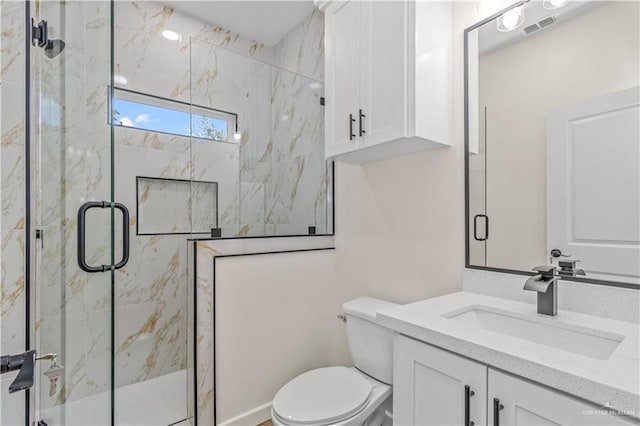 bathroom with vanity, toilet, and a shower with door