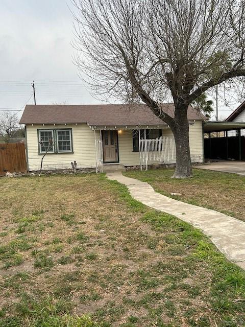 single story home with a carport and a front lawn