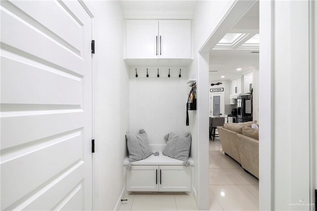 mudroom with baseboards and light tile patterned floors