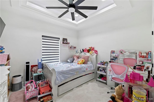 bedroom with a raised ceiling and ceiling fan