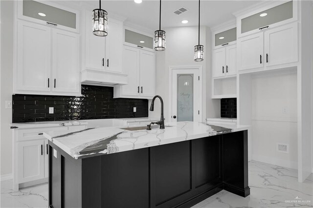 kitchen featuring a spacious island, ceiling fan, decorative light fixtures, backsplash, and white cabinetry