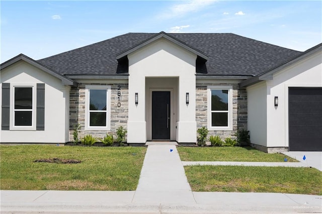 view of front facade featuring a garage and a front yard