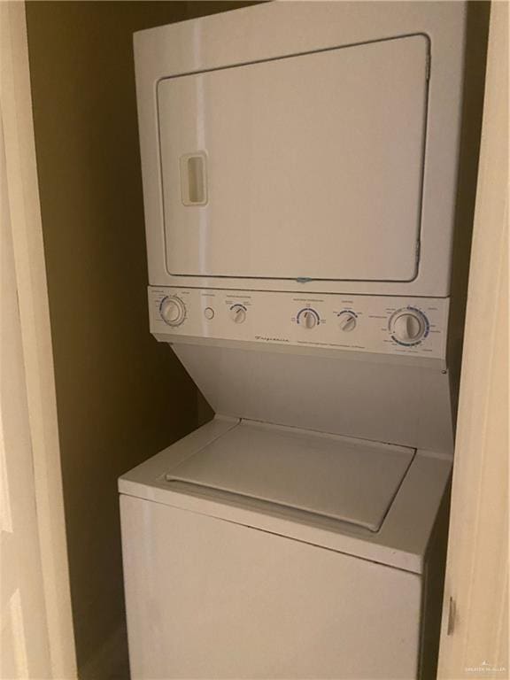 clothes washing area with stacked washer and clothes dryer