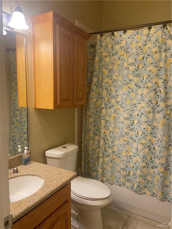 full bathroom featuring toilet, vanity, tile patterned floors, and shower / tub combo with curtain