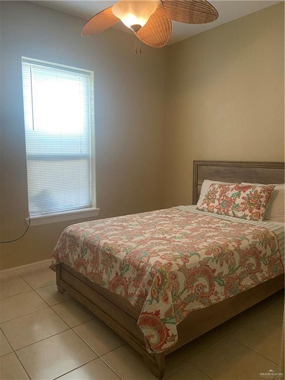 tiled bedroom featuring ceiling fan