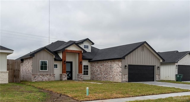 view of front of home featuring a front yard and a garage