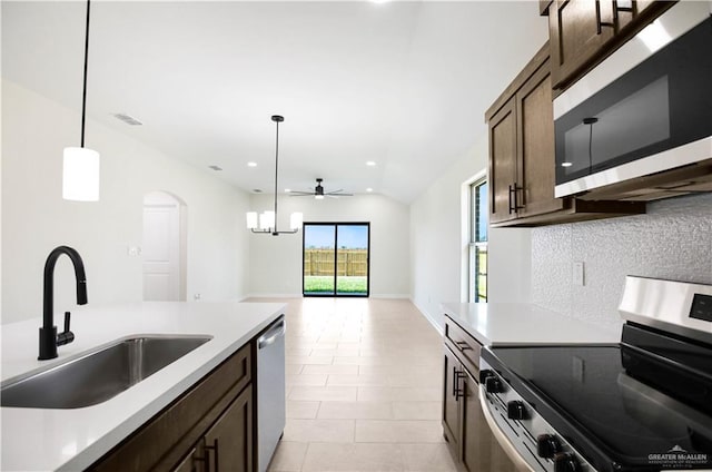 kitchen with dark brown cabinetry, appliances with stainless steel finishes, a sink, a ceiling fan, and visible vents