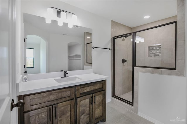 bathroom featuring vanity, tile patterned flooring, and a stall shower