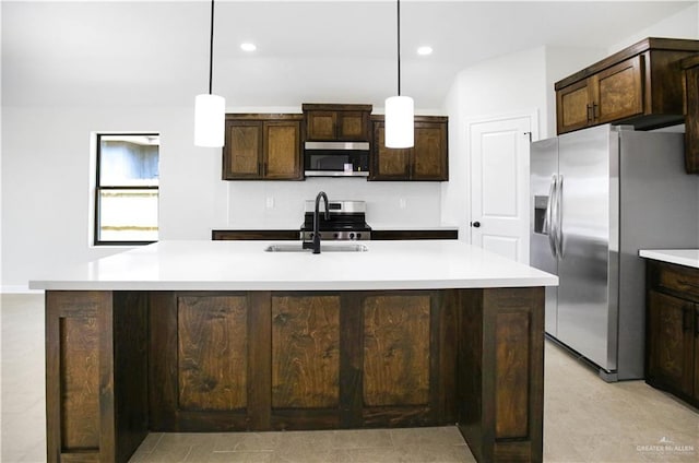 kitchen with dark brown cabinets, recessed lighting, light countertops, a sink, and appliances with stainless steel finishes