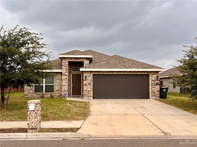 prairie-style home with a garage and a front lawn