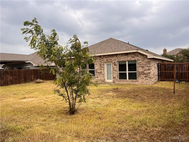 rear view of house with a lawn