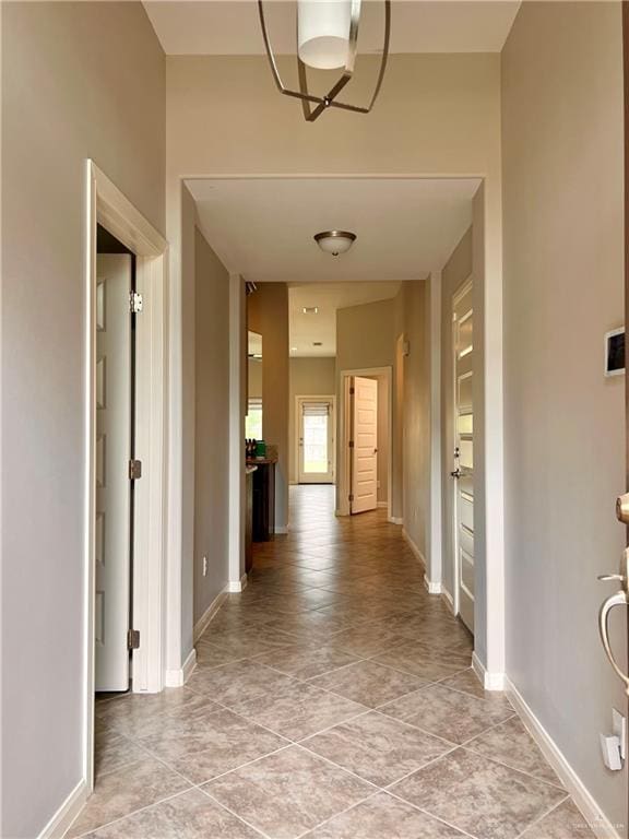 corridor with light tile patterned flooring