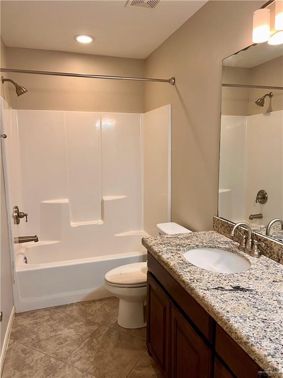 full bathroom with washtub / shower combination, vanity, and toilet