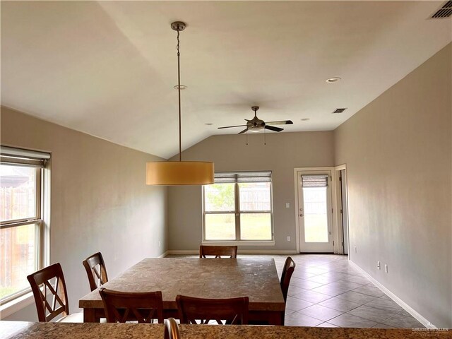 dining area featuring ceiling fan, lofted ceiling, and light tile patterned floors