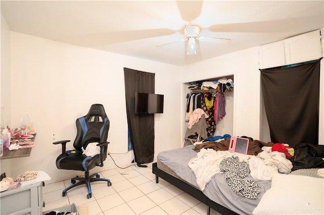 tiled bedroom with a closet and ceiling fan