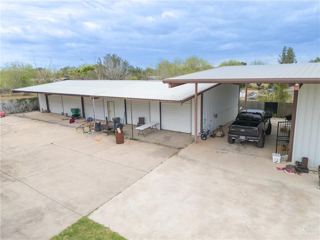 view of outbuilding featuring fence