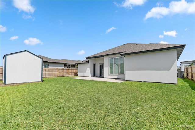 rear view of house with a yard, a patio area, and central air condition unit