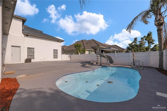 3207 E San Luis Cir, Mission, TX 78573 - view of swimming pool featuring a water slide, a fenced backyard, and a patio