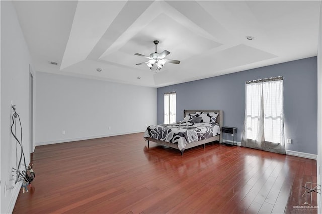3207 E San Luis Cir, Mission, TX 78573 - bedroom featuring a tray ceiling, wood finished floors, ceiling fan, and baseboards