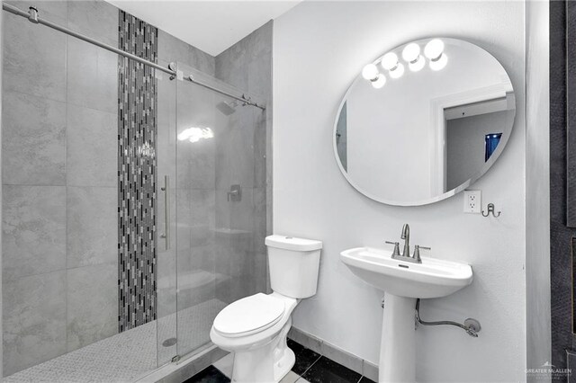 3207 E San Luis Cir, Mission, TX 78573 - bathroom featuring toilet, a shower stall, tile patterned floors, and baseboards