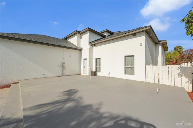 3207 E San Luis Cir, Mission, TX 78573 - rear view of house with stucco siding, a patio area, and fence