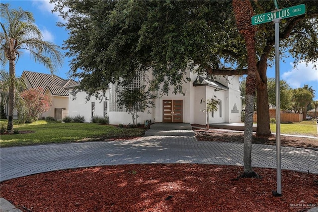 3207 E San Luis Cir, Mission, TX 78573 - view of front facade featuring french doors, stucco siding, and a front lawn