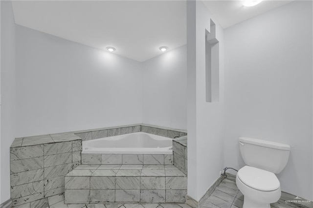 3207 E San Luis Cir, Mission, TX 78573 - bathroom with toilet, a garden tub, and marble look tile flooring