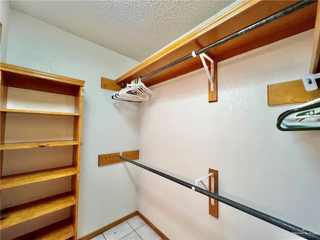 spacious closet with light tile patterned floors