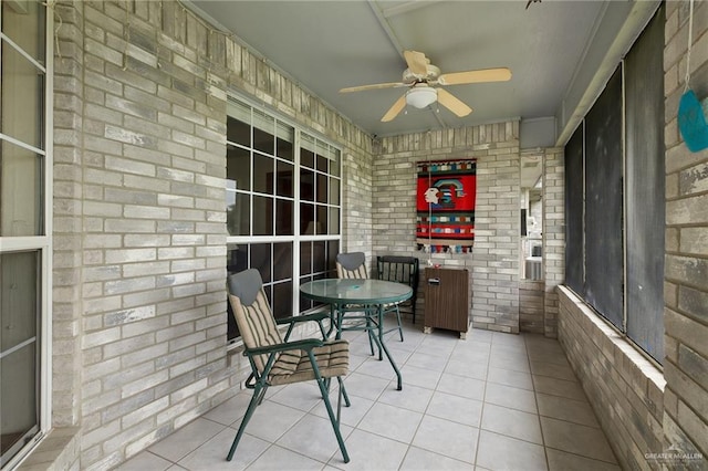 unfurnished sunroom featuring ceiling fan