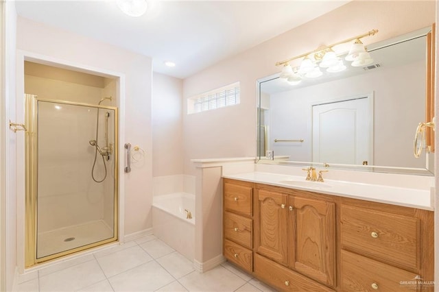 112 Saturn St, Mission, TX 78572 - bathroom with tile patterned flooring, a shower stall, vanity, a garden tub, and baseboards