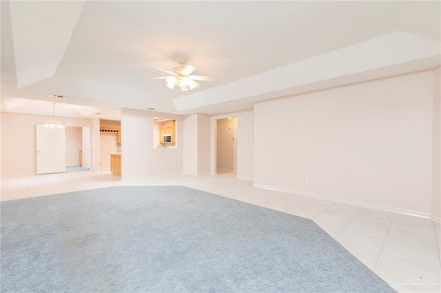 112 Saturn St, Mission, TX 78572 - spare room with a raised ceiling, light tile patterned flooring, and light carpet