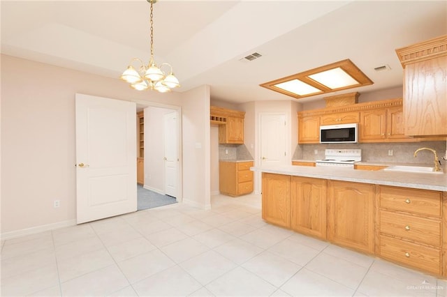 112 Saturn St, Mission, TX 78572 - kitchen with a sink, white appliances, light countertops, and decorative backsplash
