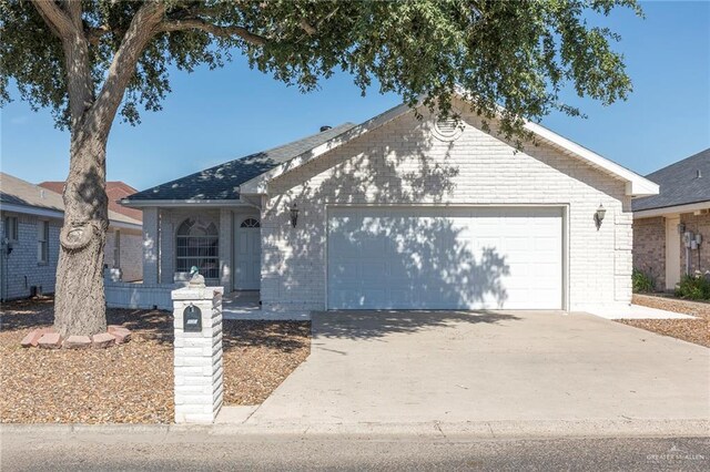 112 Saturn St, Mission, TX 78572 - single story home featuring brick siding, an attached garage, and concrete driveway