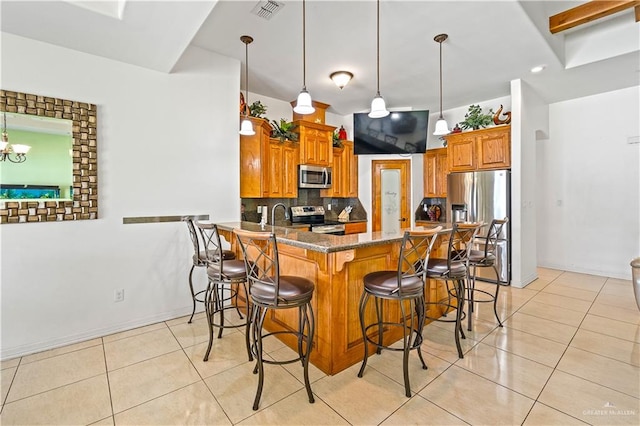 kitchen featuring brown cabinets, light tile patterned floors, visible vents, backsplash, and appliances with stainless steel finishes