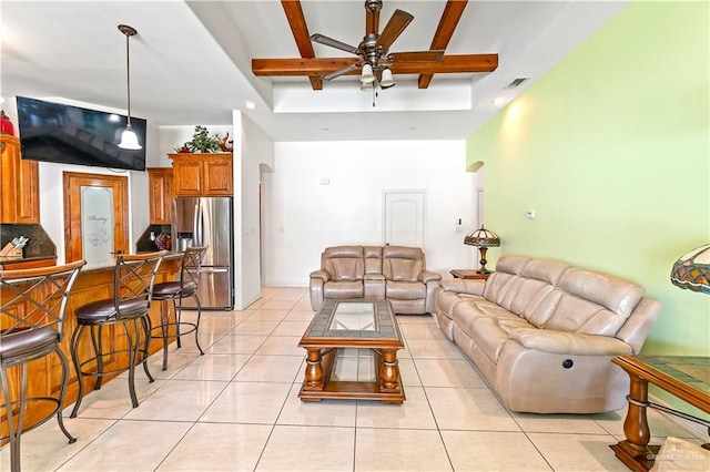 living area with beam ceiling, light tile patterned flooring, visible vents, and a ceiling fan