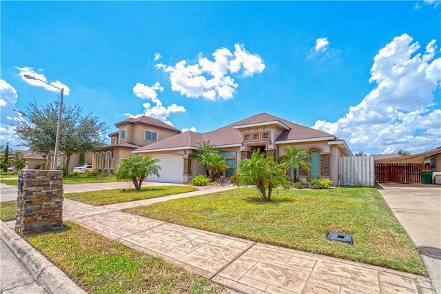 mediterranean / spanish-style house featuring driveway, stucco siding, a garage, and a front yard