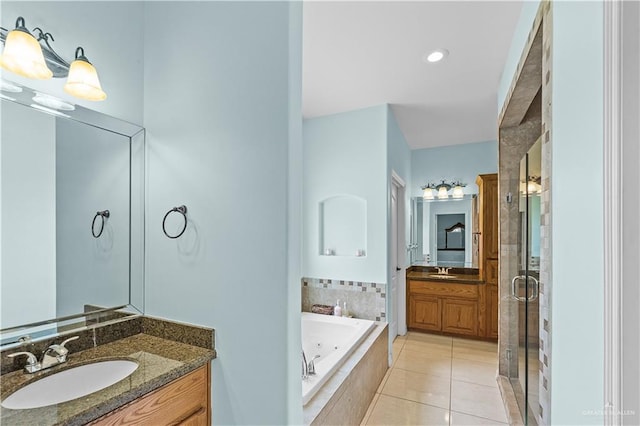 full bathroom with two vanities, a garden tub, a sink, and a shower stall