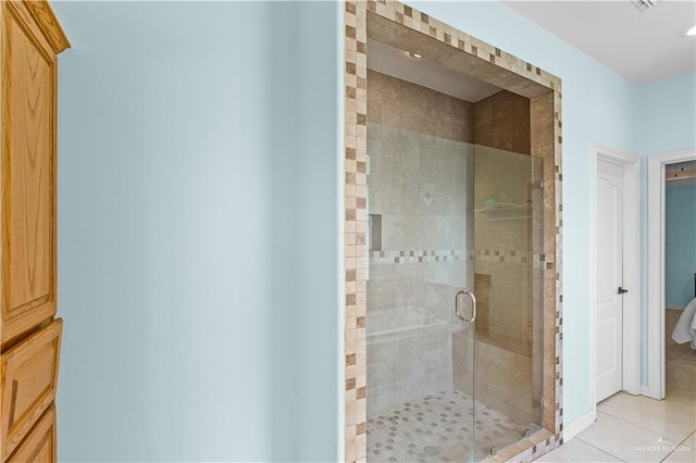 bathroom featuring a stall shower and tile patterned flooring