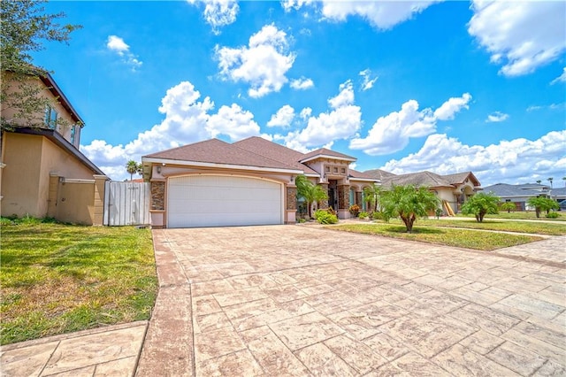 mediterranean / spanish-style house featuring driveway, a front lawn, an attached garage, and a gate