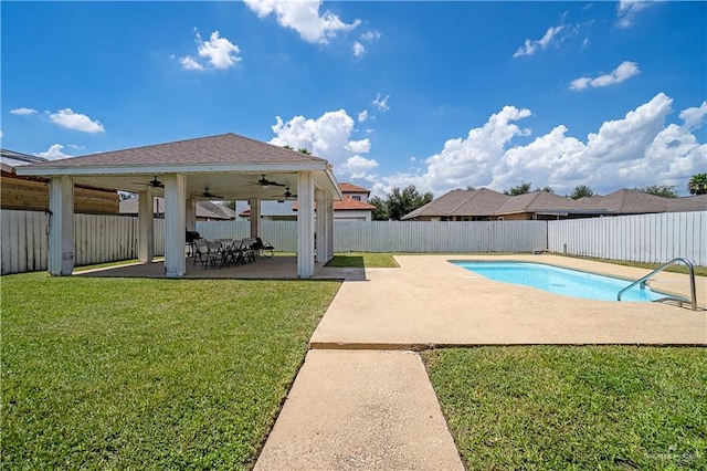 view of pool with ceiling fan, a patio, a fenced backyard, a lawn, and a fenced in pool